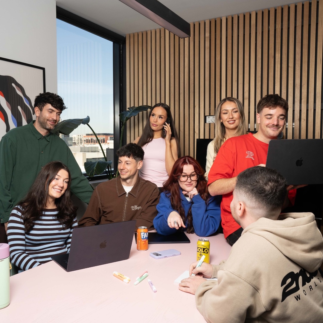 The Pulp Digital team around the boardroom table, going through work together on their laptops