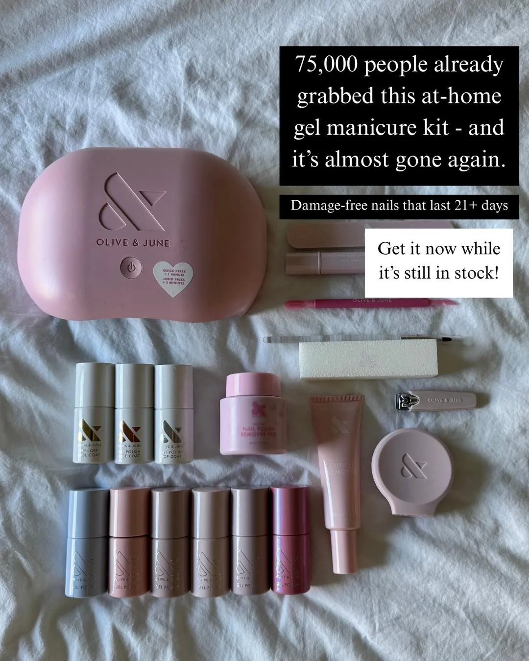 A flatlay of an Olive & June at-home gel manicure kit on bedsheets: lamp, polishes and tools, with “75,000 people already grabbed this” overlaid