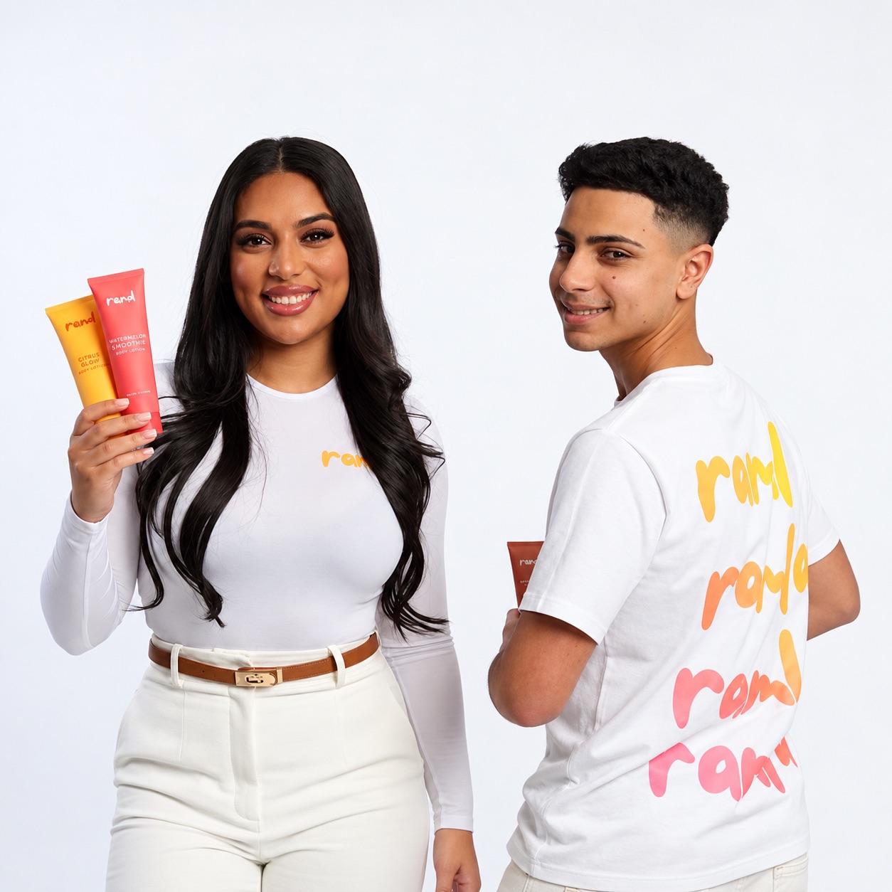 Two models holding Ramla Body lotions, wearing tees printed with the Ramla wordmark